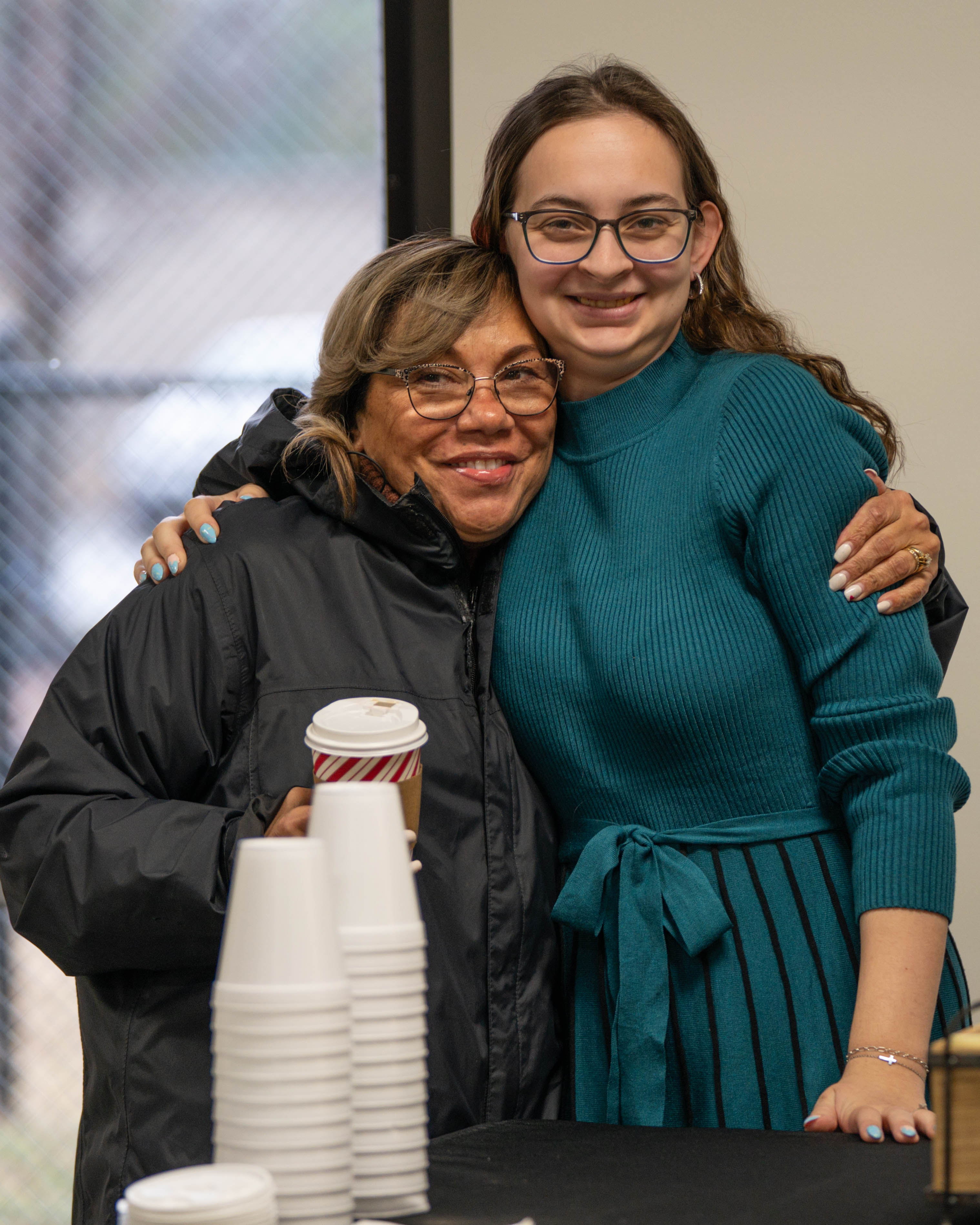 Two women embracing at a Victory Church small group